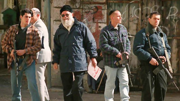Rabbi Moshe Levinger (centre) is escorted by bodyguards in central Hebron during a protest against the   first Palestinian Authority elections in 1996.