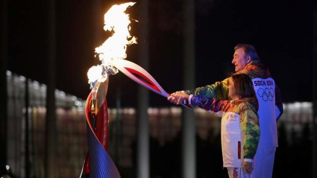 Former ice-hockey player Vladislav Tretiak and figure skater Irina Rodnina light the Olympic Cauldron.