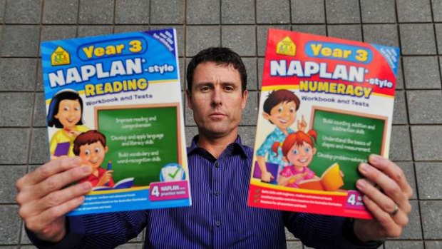 Australian Education Union ACT branch president Glenn Fowler with the popular workbooks. He said parents need to understand the assessments are "not the HSC for seven-year-olds''.
