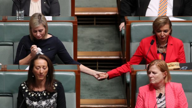 Susan Lamb holds hands with Anne Aly as Bill Shorten talks about the death of Binni Kirkbright-Burney, the son of Linda Burney.