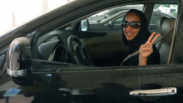 Saudi activist Manal Al Sharif, who now lives in Dubai, flashes the sign for victory as she drives her car in solidarity with Saudi women preparing to take to the wheel on Saturday.