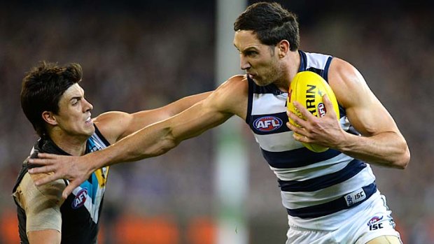 Hands off: Geelong's Harry Taylor pushes past Angus Monfries.