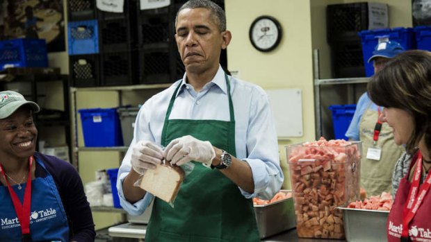 Hands on: Barack Obama joins government workers doing volunteer work during the shutdown.
