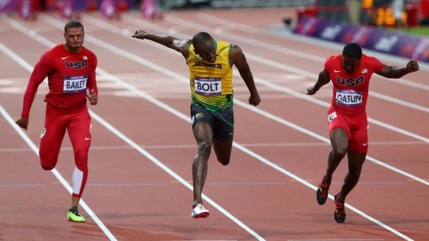 Golden boy ... Usain Bolt of Jamaica crosses the finish line ahead of Ryan Bailey and Justin Gatlin.