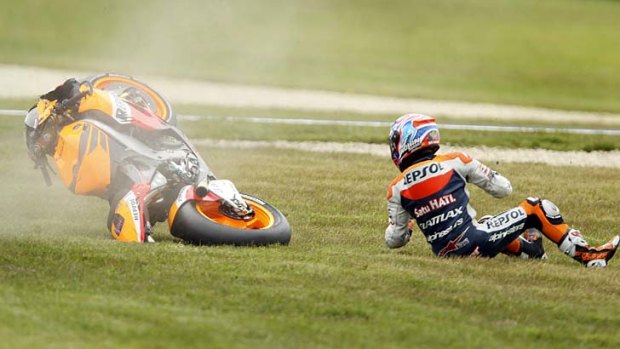 Down but unhurt: Casey Stoner watches his bike land during a crash in the qualifying session yesterday.
