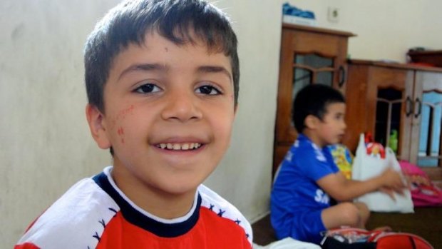 All smiles: A young boy at the learning centre.