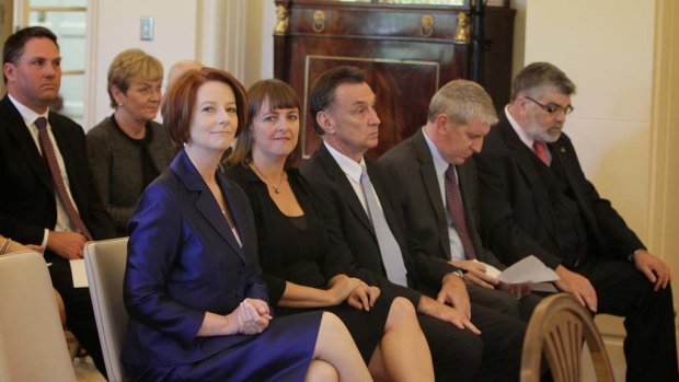 Prime Minister Julia Gillard looks on as new members of her ministry are sworn in.
