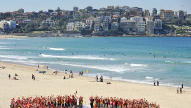 Up in arms... protesters on Bondi Beach form a giant ring in support of asylum seekers yesterday.