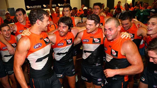Tuning up for the big year: Recruits Shane Mumford, Dylan Addison, Heath Shaw and Josh Hunt lead the Giants in the team song at Homebush Bay on Saturday.