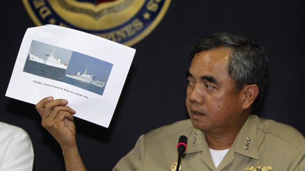 Alexander Pama of the Philippine Navy presents an undated file photo of a Chinese surveillance ship.