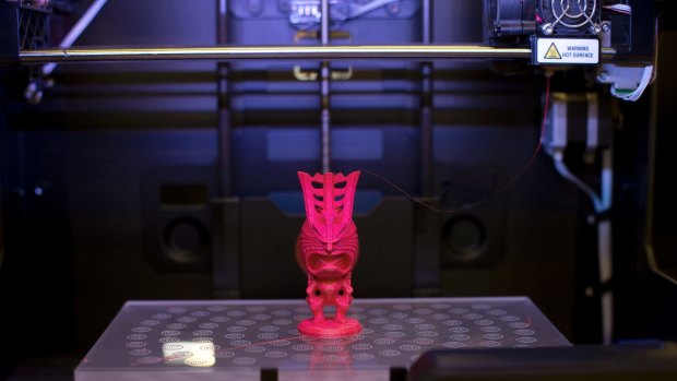 A figurine is constructed in a Makerbot printer.