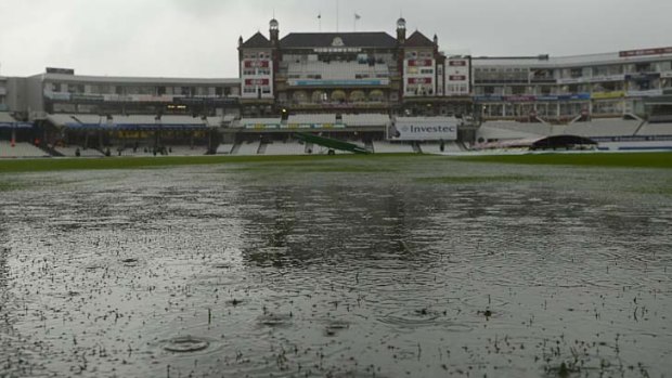 Damp times: Rain produces a huge puddle in the fifth Test.