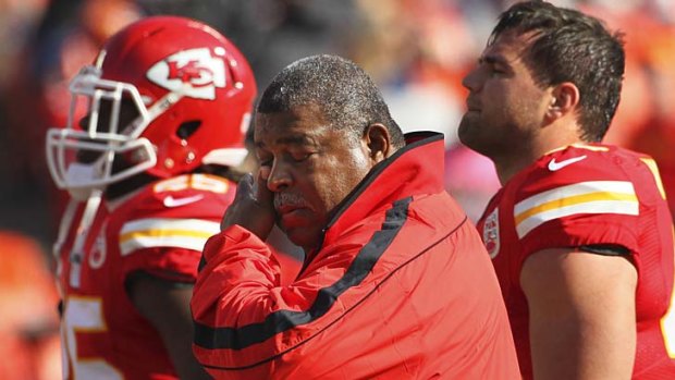 Kansas City Chiefs coach Romeo Crennel wipes his eyes before Sunday's match against the Panthers.
