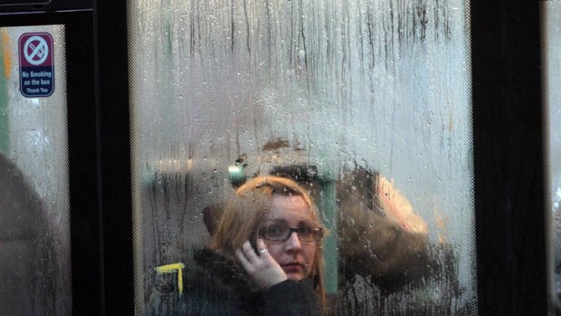 Miserable weather ... a woman on a bus looks at the rain in Bristol.