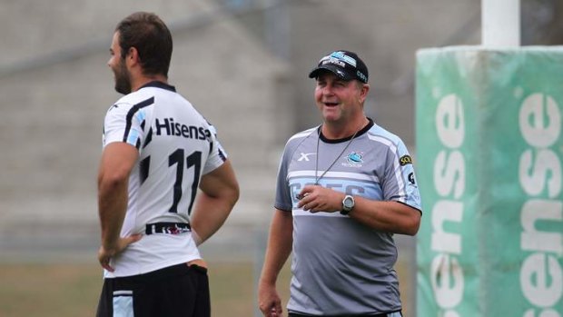 Reluctant head coach: Peter Sharp puts Wade Graham (left) and his Cronulla teammates through some drills on Thursday.