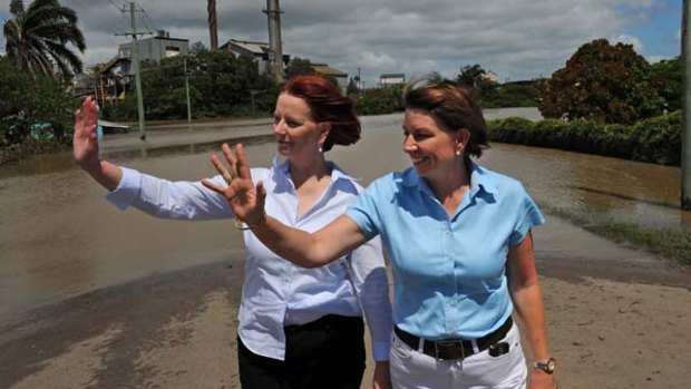 Prime Minister Julia Gillard and Queensland Premier Anna Bligh inspect a flooded neighbourhood near the famous rum distillery in Bundaberg.