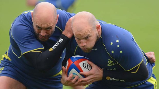 Push and shove ... Wallabies forwards Nathan Sharpe and Stephen Moore train at a London school for the Test against England at Twickenham on Saturday.