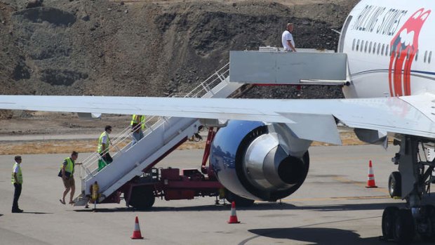 Flight crew are seen boarding the Aeronexus Corporation's - Boeing 767 used by the Rolling Stones for pre-flight checks at Perth international airport.