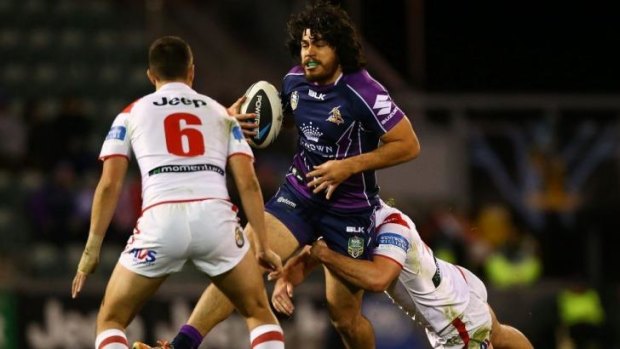 Breathing fire against the Dragons: Melbourne forward Tohu Harris attempts to break a tackle.