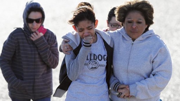 In shock: Students are reunited with families following an early morning shooting at Berrendo Middle School in Roswell, New Mexico.