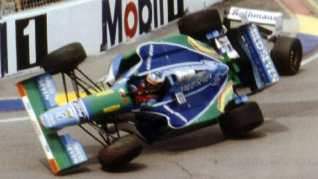 Risky: Michael Schumacher after clipping Damon Hill.