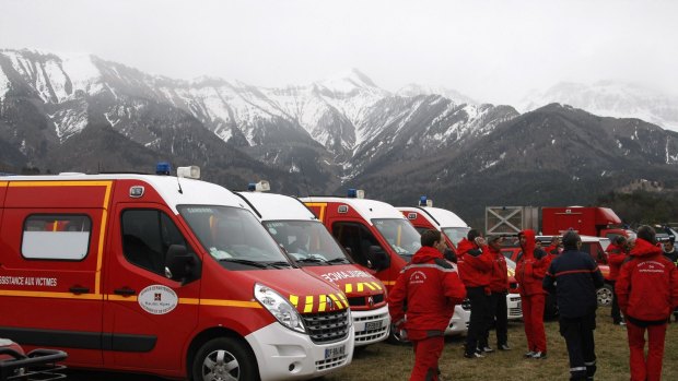 Rescue workers and ambulances ready to provide assistance at the Germanwings crash site near Seyne les Alpes on Tuesday.