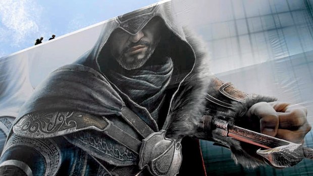 Workers finish installing a billboard for Ubisoft Assassin's Creed 3 in Los Angeles.