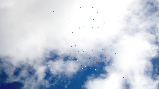 Red, white and blue baloons released at the funeral of Regan Burton.