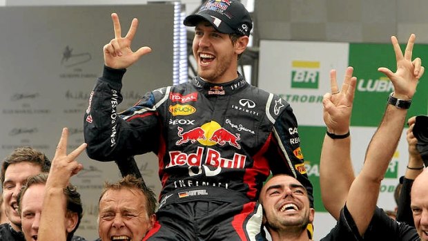 Three-peat ... Sebastian Vettel celebrates his F-1 World Championship with Red Bull teammates.