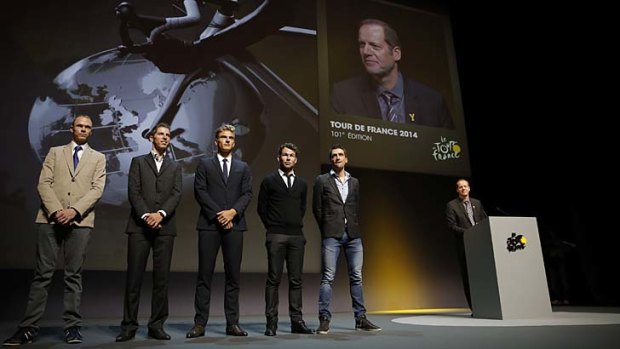 Cyclists Christopher Froome, Rui Costa, Marcel Kittel, Mark Cavendish and Christophe Riblon pose next to Tour de France director Christian Prudhomme after the unveiling of the route for the 2014 Tour de France in Paris on Wednesday.