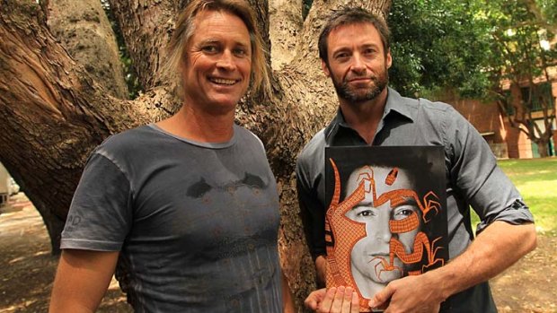 Hugh Jackman, with photographer Russell James, is helping launch his new book. "Nomad Two Worlds".