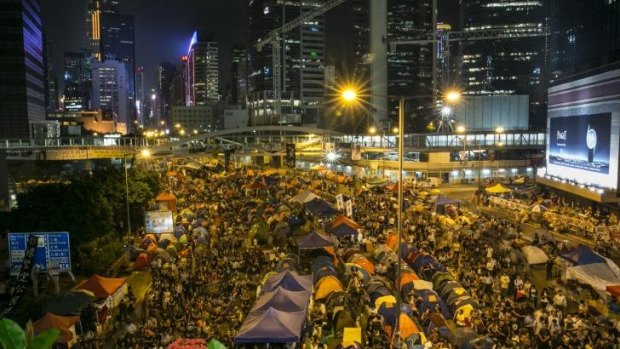 Enthralled: Tens of thousands of protesters gather to listen to the talks at the main protest site in Hong Kong. 