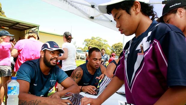 Right code: Kurtley Beale spreads the message to youngsters at the Rebels clinic at Frankston.