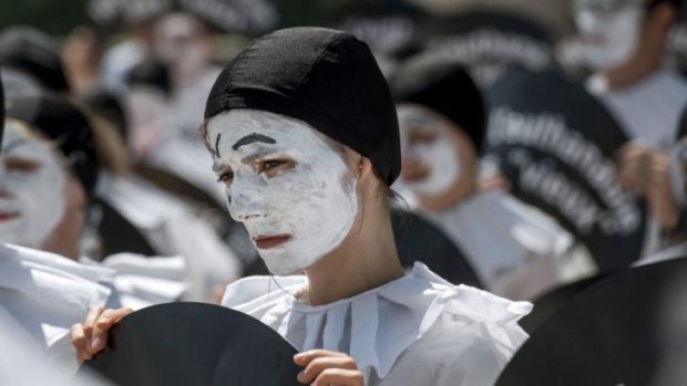People dressed as the traditional theatre character "Pierrot" take part in a demonstration against euthanasia on Tuesday on the Trocadero esplanade, near the Eiffel Tower in Paris.