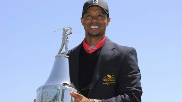 No.1 again: Tiger Woods  holds the trophy after he won the Arnold Palmer Invitational PGA golf tournament.