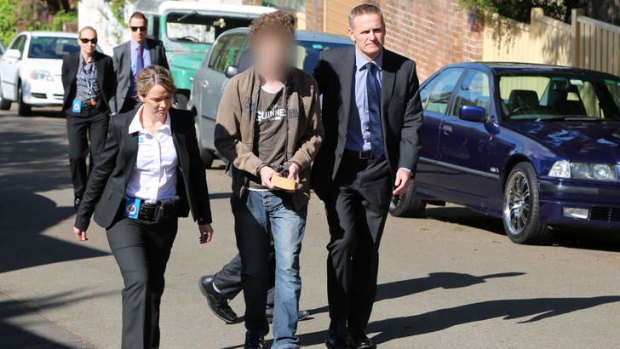 The man accused of murdering Morgan Huxley is led away by police.