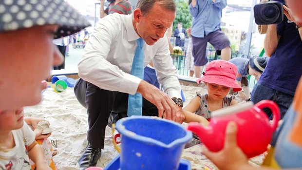 Yes, he can ... Tony Abbott shows his softer side at a Brisbane childcare centre last week.