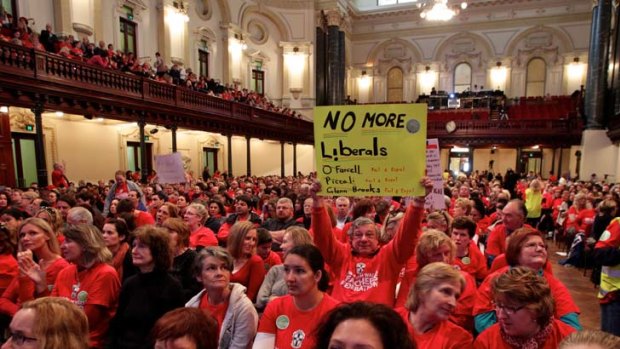 ''We will not be intimidated'' ... Maurie Mulheron, the president of the NSW Teachers Federation said. Public school teachers gather inside the Town Hall during their strike action.