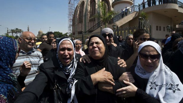 Relatives of the four policemen, killed during clashes with Muslim Brotherhood supporters earlier in the week, mourn during their funeral in Cairo.