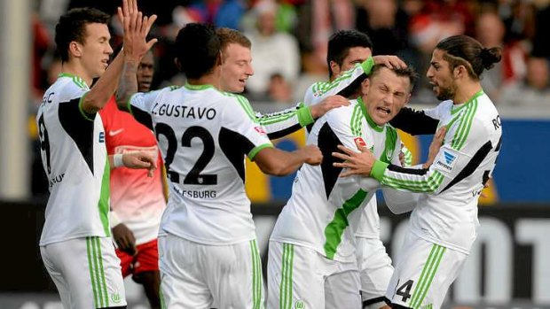 Wolfsburg's players celebrate a goal.