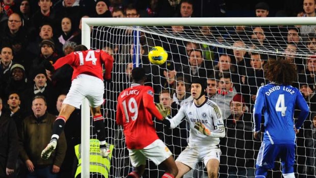 Goalkeeper Petr Cech of Chelsea fails to stop Javier Hernandez of Manchester United scoring their third goal.