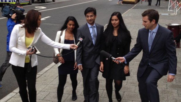 Lloyd Rayney arriving at court with his daughters, Caitlyn and Sarah.