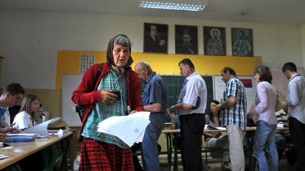 Serbians wait to vote at a polling station in Belgrade.