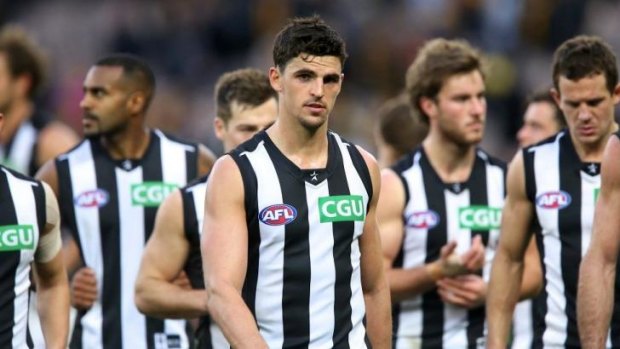 Scott Pendlebury leads his dejected team off the MCG.