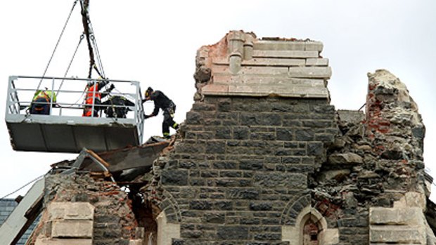 Urban search and rescue specialists scour the ruins of Christchurch Cathedral yesterday.