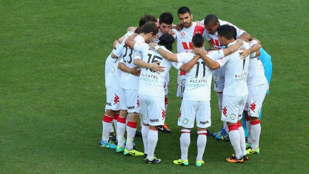 Huddle up: Heart players talk tactics before the game against Brisbane Roar.