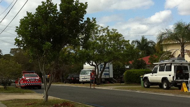 A removal truck at a house on Douglas Street, in Logan.