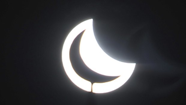 The minaret of a mosque is silhouetted against the solar eclipse in Yinchuan, China.