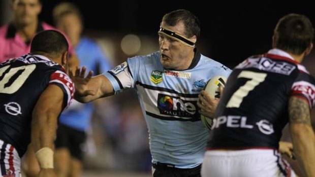 Leader of the pack: Paul Gallen puts on a big fend.