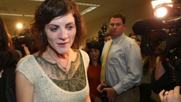 Rachel MacNeill walks away from the media after her father was found guilty of the murder of  her mother.